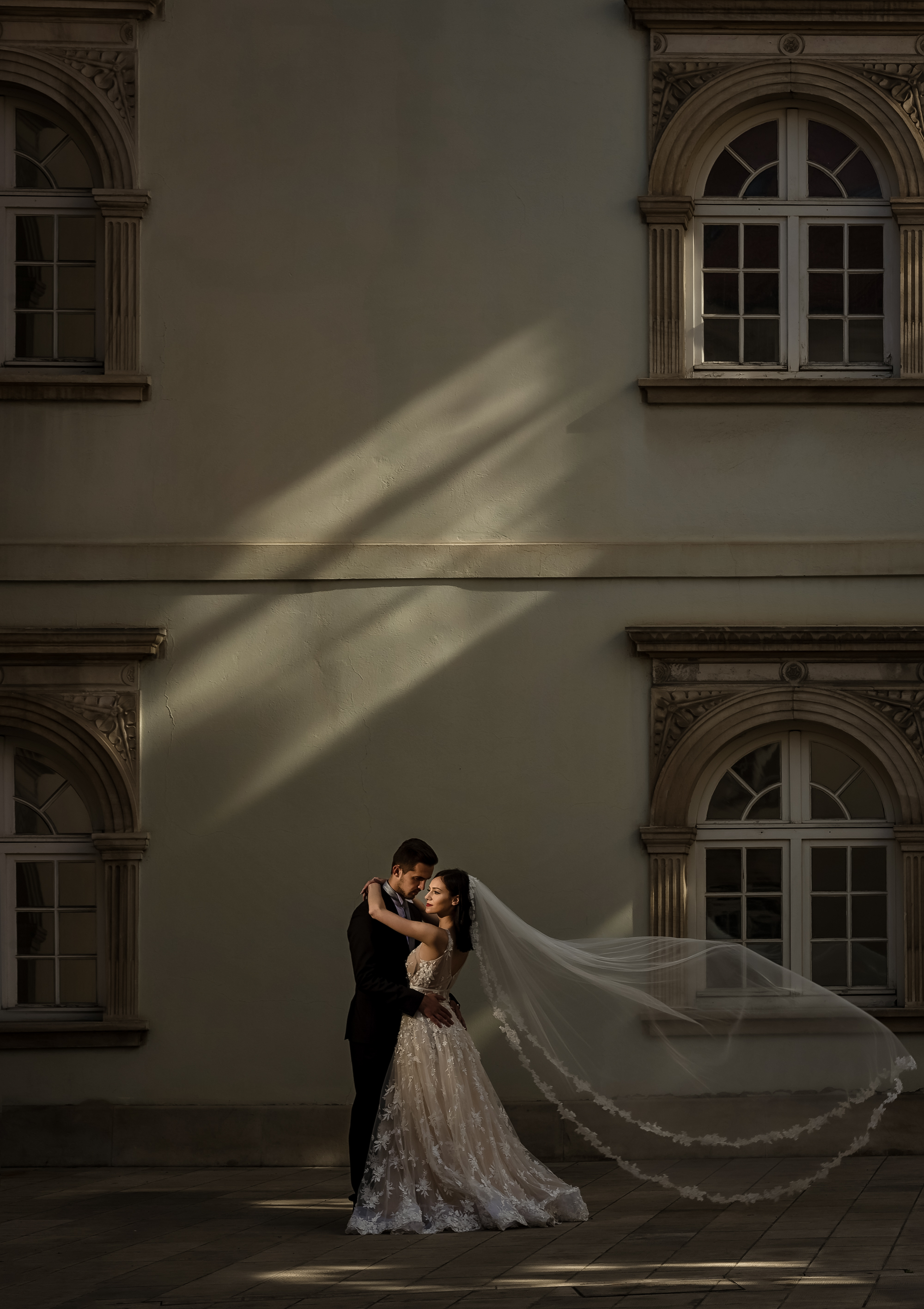 bride and groom in kissing pose in front of building in Dubrovnik