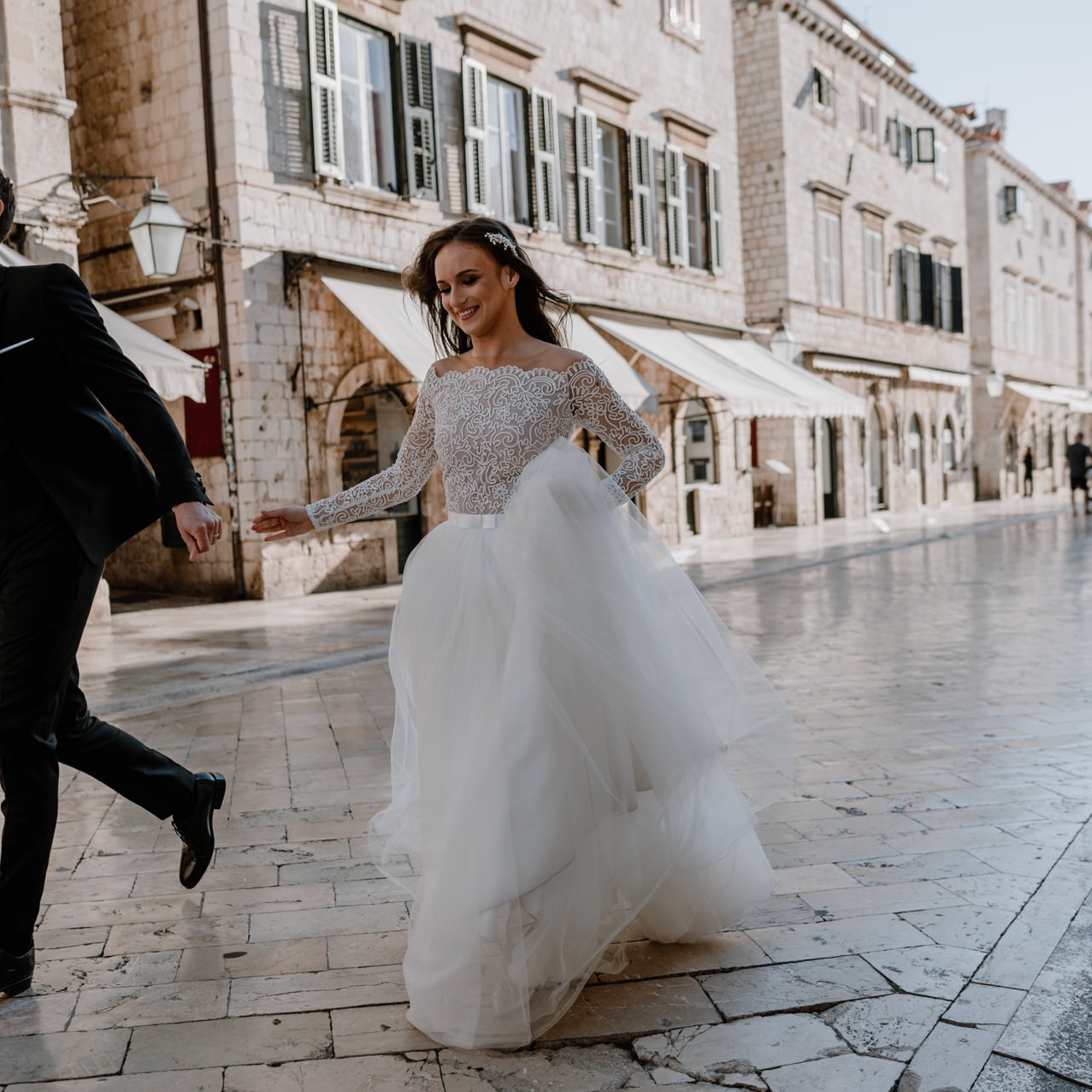 bride and groom running down the street